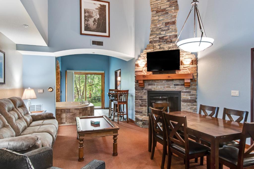 ein Wohnzimmer mit einem Tisch und einem Kamin in der Unterkunft Chula Vista Condo 2145 & 2147 Full Property in Wisconsin Dells