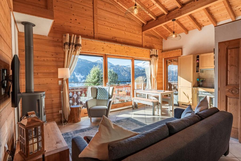 a living room with a couch and a table at Beautiful 2 bed Chalet Morzine in Morzine