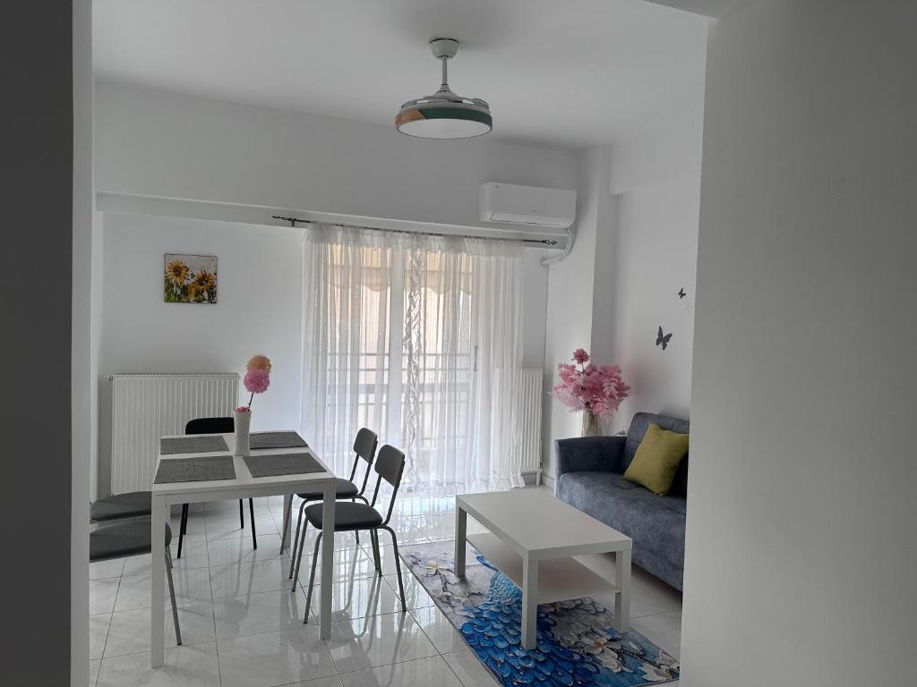 a living room with a table and a couch at Pireas new hotel in Piraeus