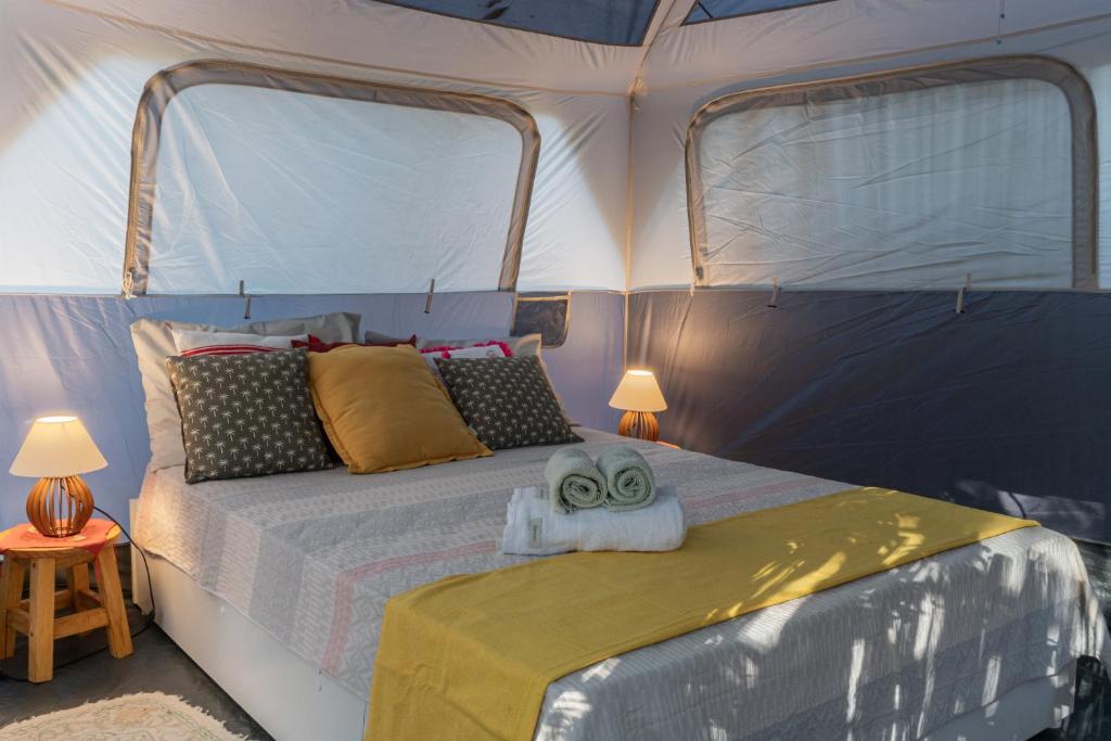 a bedroom with a bed in a tent at Glamping Coco Dendê - Algodões in Praia dos Algodões