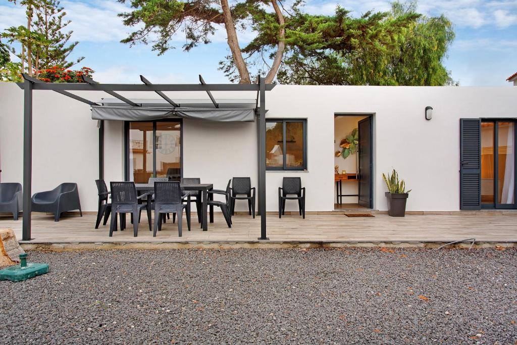 Vila BaleiraにあるCasa Fonte São Joãoのパティオ(テーブル、木製デッキの椅子付)