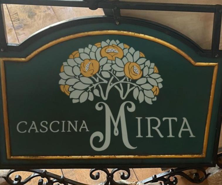 a sign for a casita mirta with a flower on it at CascinaMirta in Andorno Micca