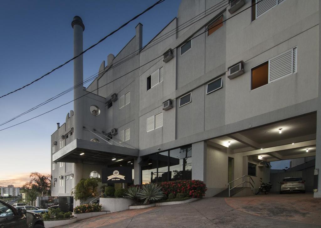 a building with a car parked in front of it at JP Palace Hotel in Franca