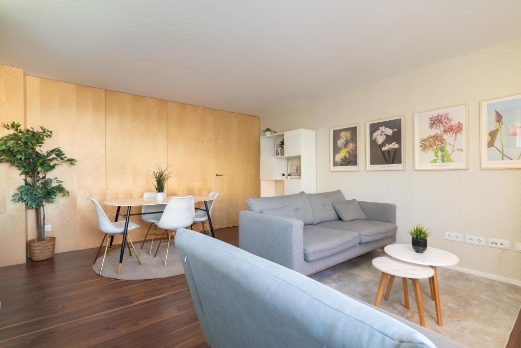 ein Wohnzimmer mit einem Sofa und einem Tisch in der Unterkunft Restful Minimalist Flat - Balcony in Porto