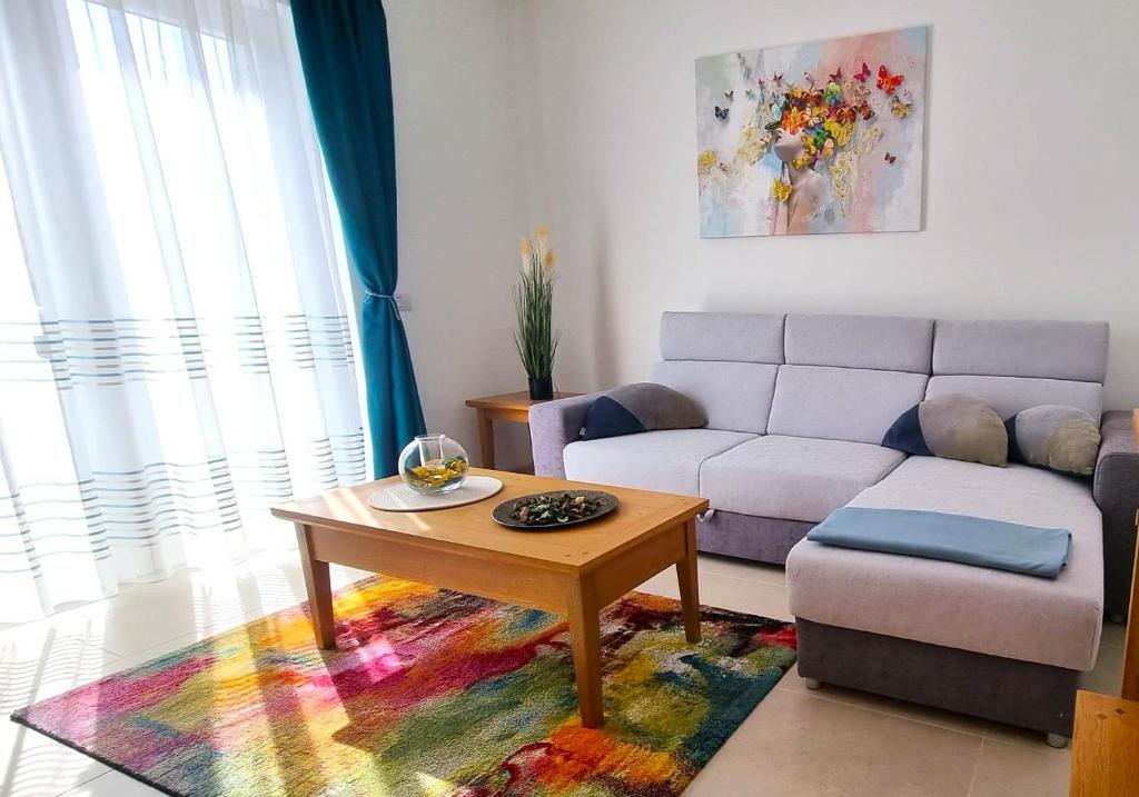 a living room with a couch and a coffee table at Bella Vista Red Apartment in Braşov