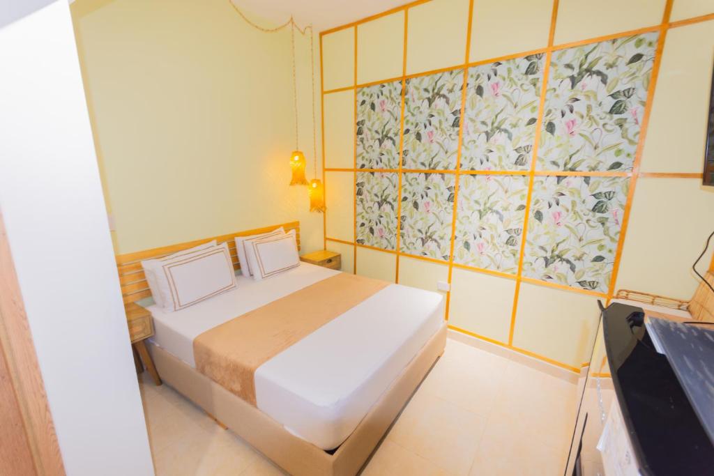 Postel nebo postele na pokoji v ubytování La Casona Hotel Boutique