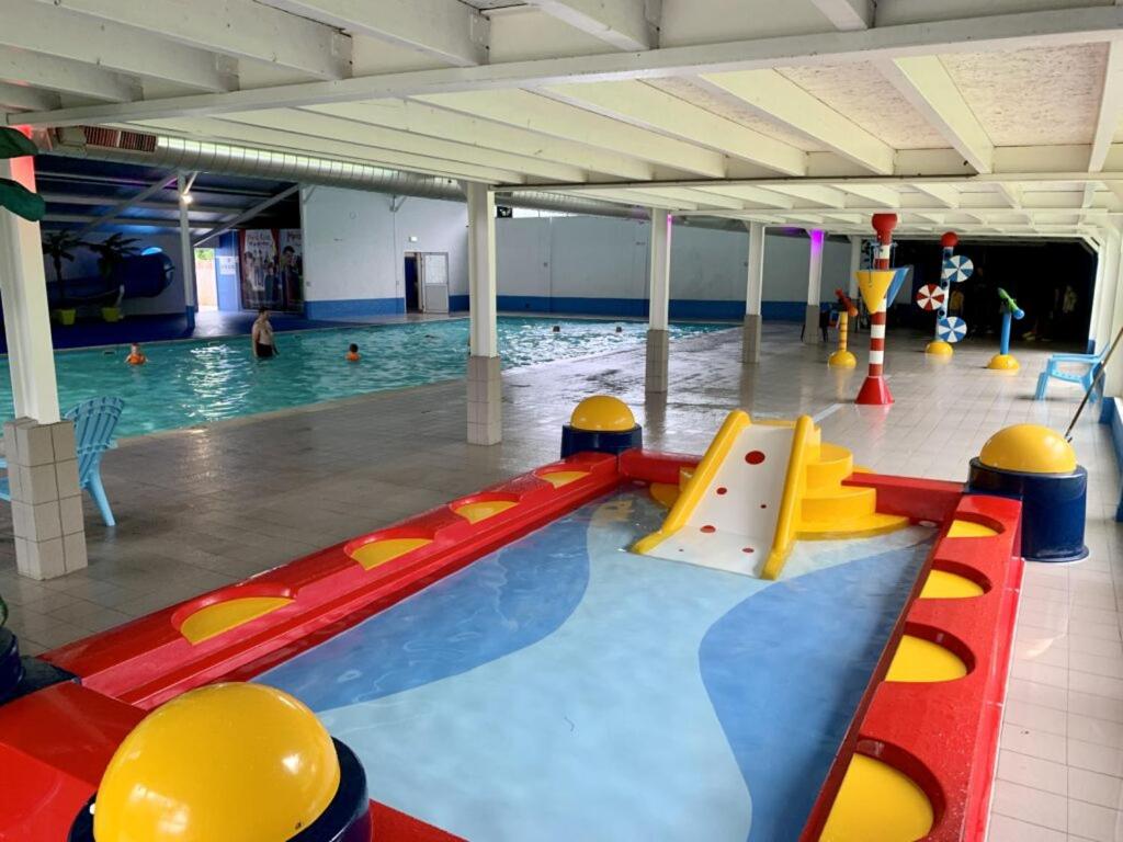 a swimming pool with a bunch of equipment in it at Camping de Rammelbeek in Lattrop