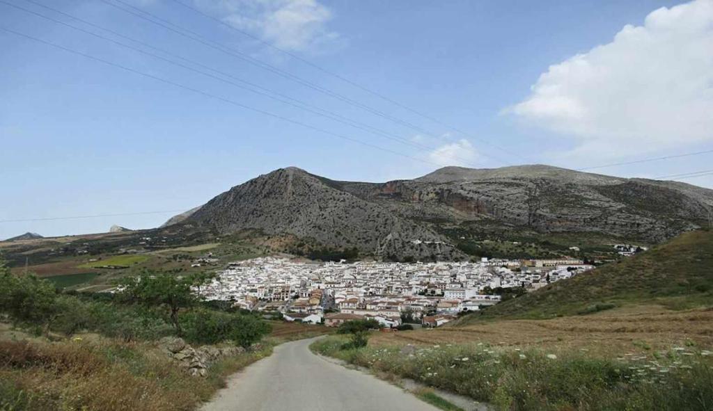 a village on a mountain with a dirt road at Casabell 3 Caminito del Rey in Valle de Abdalagís