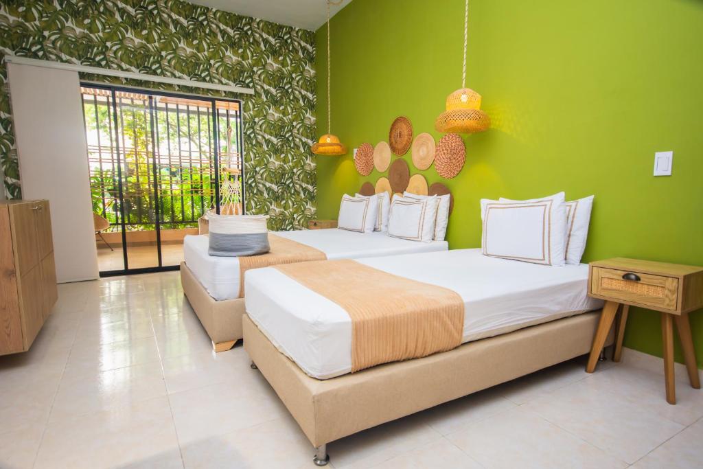 Postel nebo postele na pokoji v ubytování La Casona Hotel Boutique