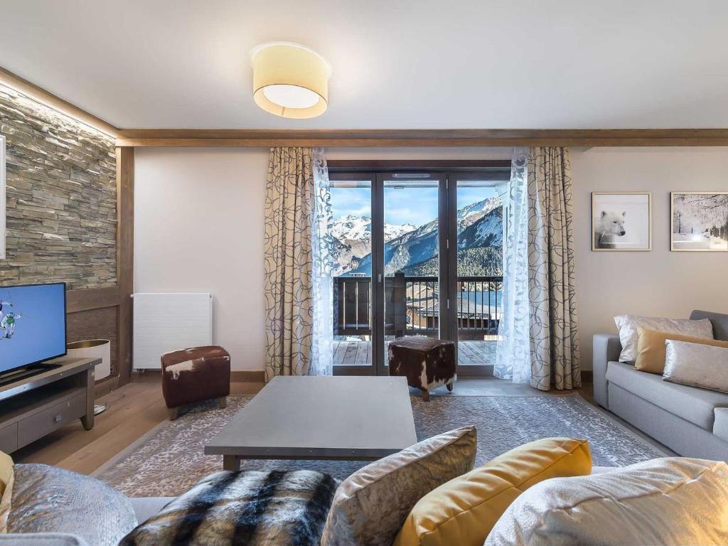 a living room with a couch and a table at Appartement Courchevel 1550, 4 pièces, 8 personnes - FR-1-562-19 in Courchevel