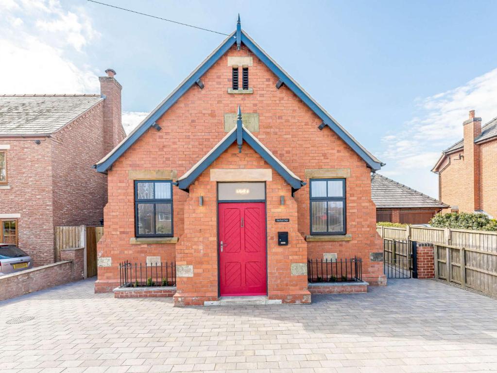 a red brick building with a red door at 2 bed in Ellesmere 62544 in Ellesmere