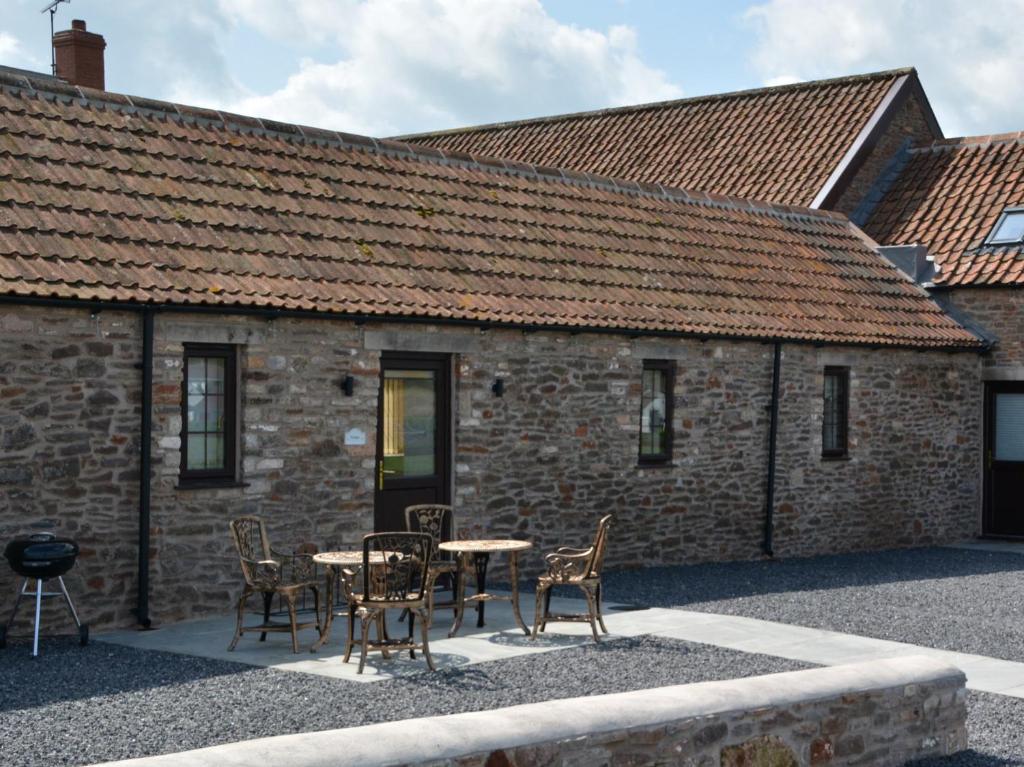 a table and chairs in front of a brick building at 2 bed property in Bath 72837 in Chew Magna