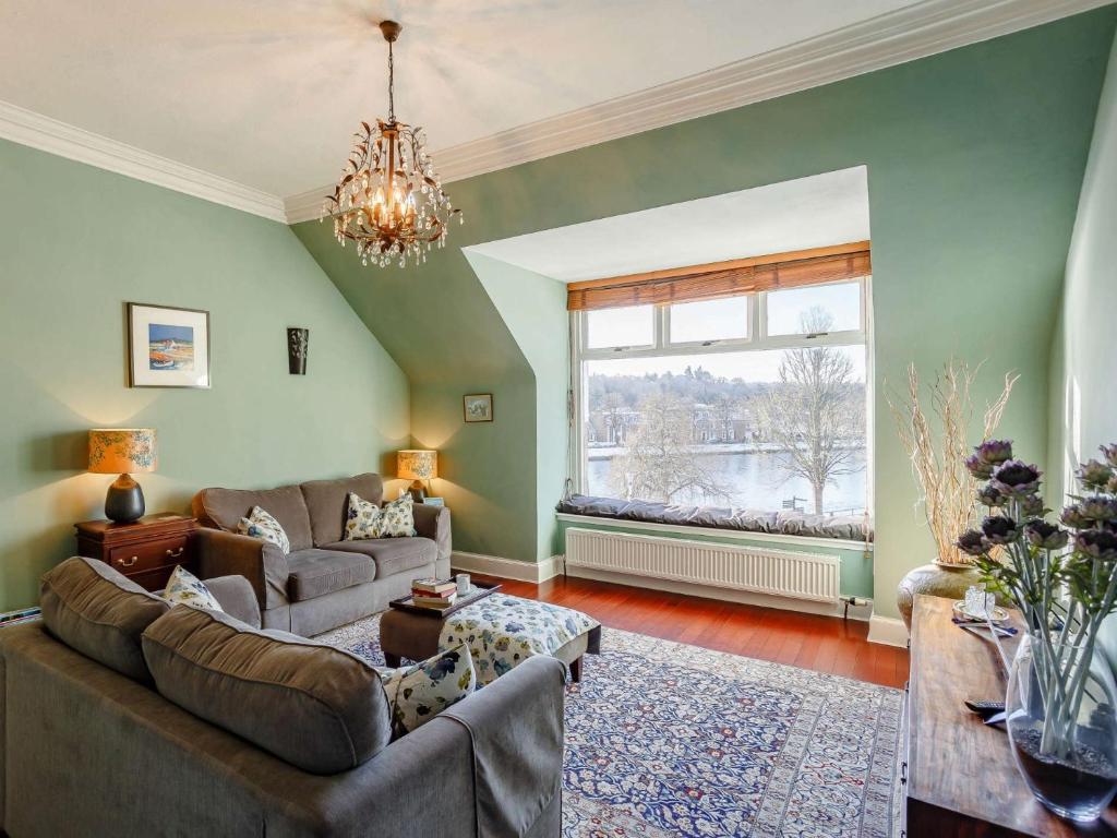 a living room with green walls and a large window at 2 bed in Inverness CA328 in Inverness