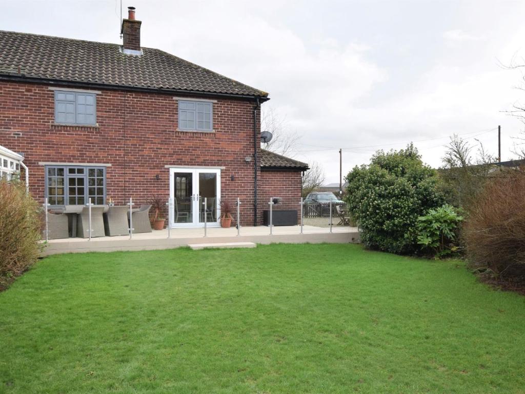 a brick house with a lawn in front of it at 3 bed in York HH015 in Tockwith
