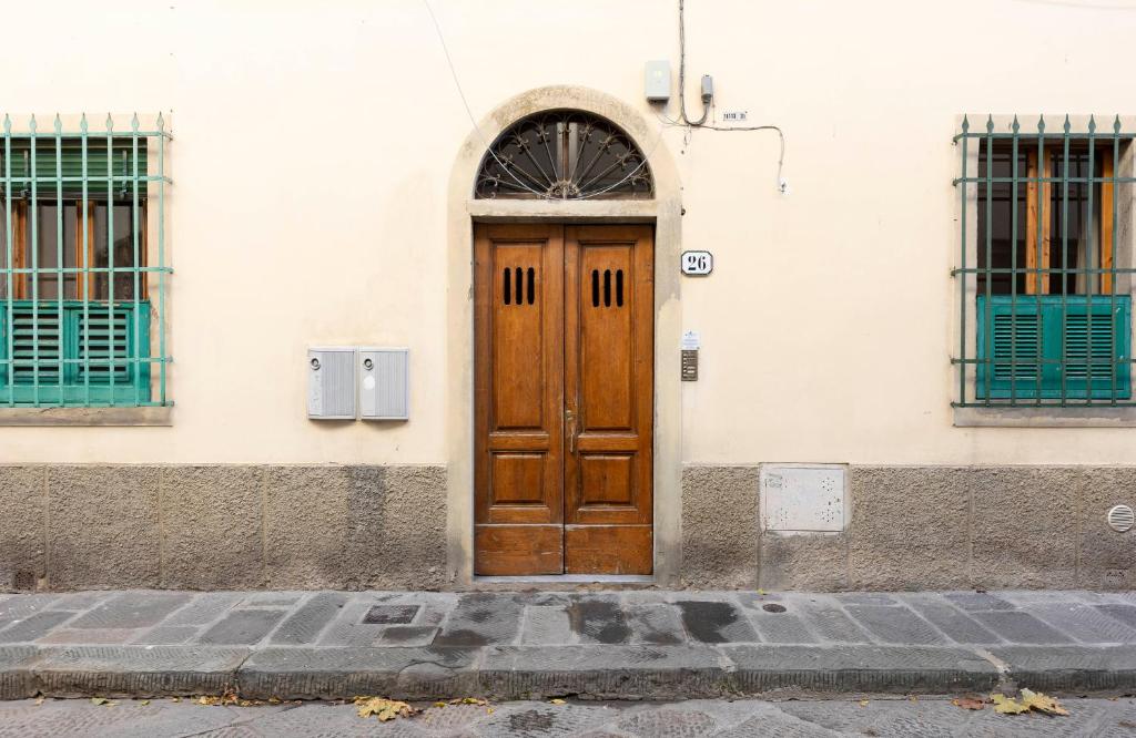a wooden door on the side of a building at Santa Croce Comfort Apartment in Florence