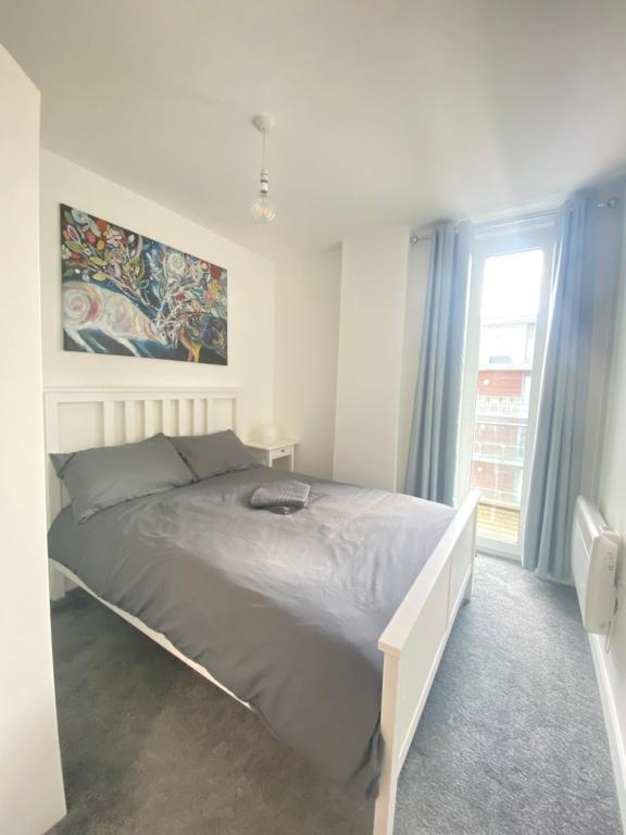 a bedroom with a large bed in a room with a window at Modern Double Room in Manchester