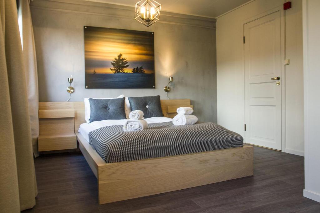 a bedroom with a bed and a dresser at Lillehammer Turistsenter Budget Hotel in Lillehammer