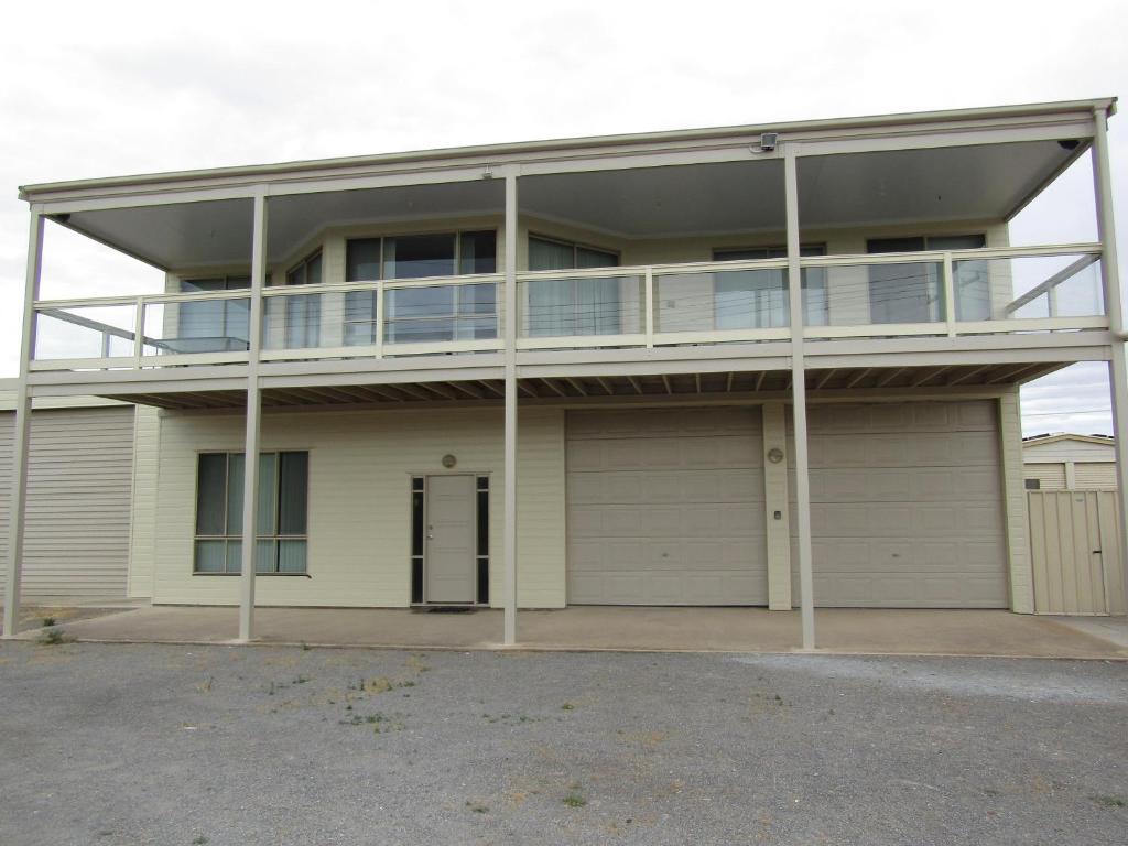 a large house with a balcony and a garage at Hardwicke Espy in Brentwood