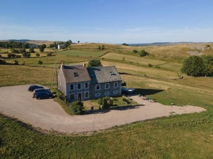 an aerial view of a large house in a field at Le Buron du Bessou in Saint-Urcize