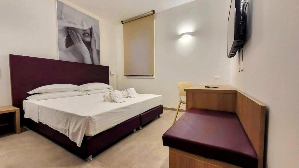 a bedroom with a large bed and a table at A Nanein con Joy in Bologna