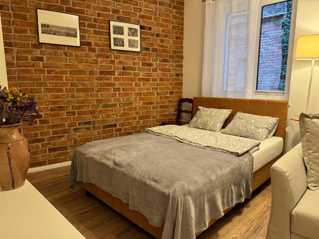 Postel nebo postele na pokoji v ubytování Apartamenty Ceglane
