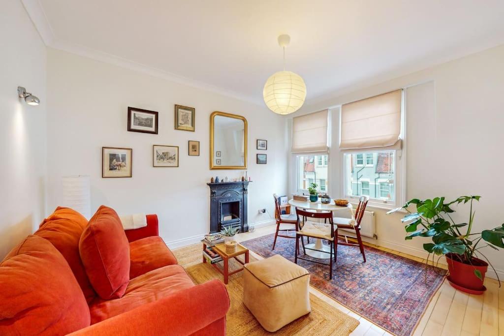 a living room with a couch and a table at Stunning 1 bed apartment in Fulham in London