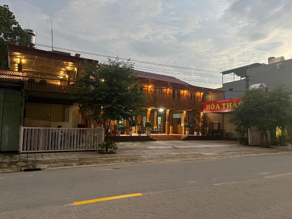 a building with a sign on the side of a street at Homestay Hoa Thao in Mù Cang Chải