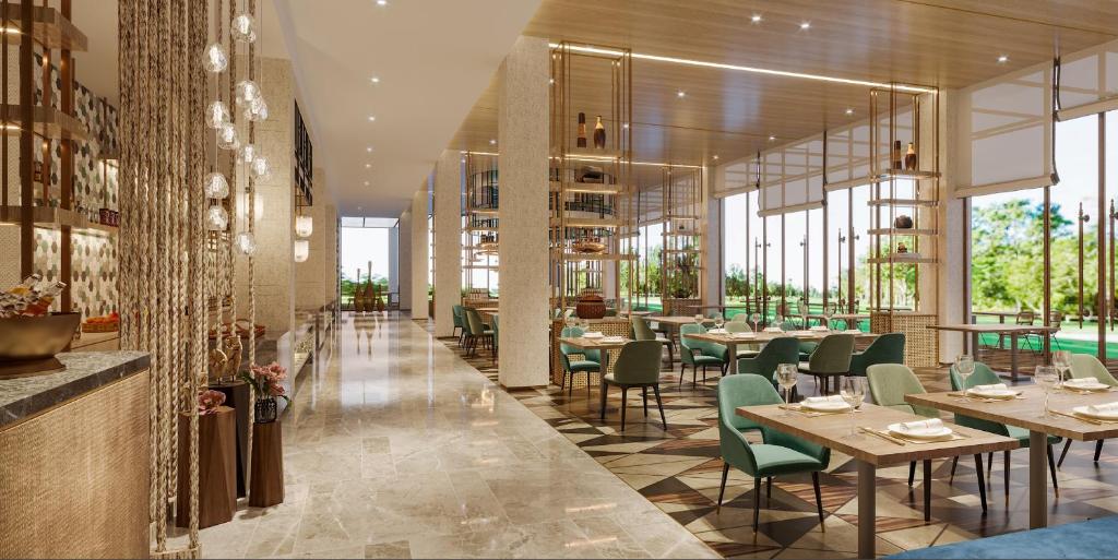 a restaurant with tables and chairs and windows at Argyle Grand Hotel Nairobi Airport in Nairobi