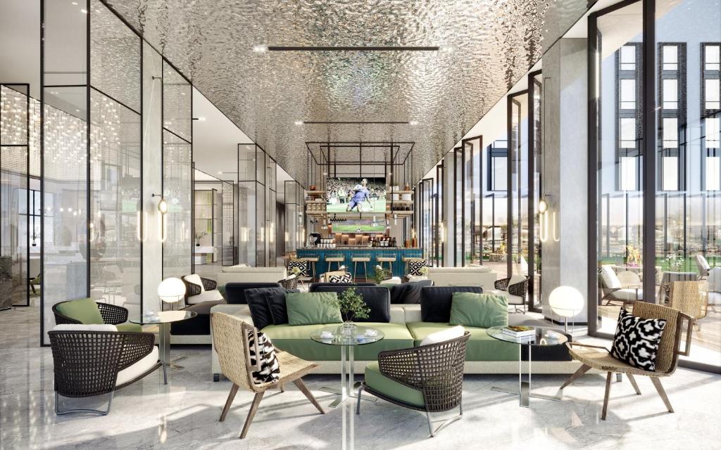 a lobby with a couch and tables and chairs at Argyle Grand Hotel Nairobi Airport in Nairobi