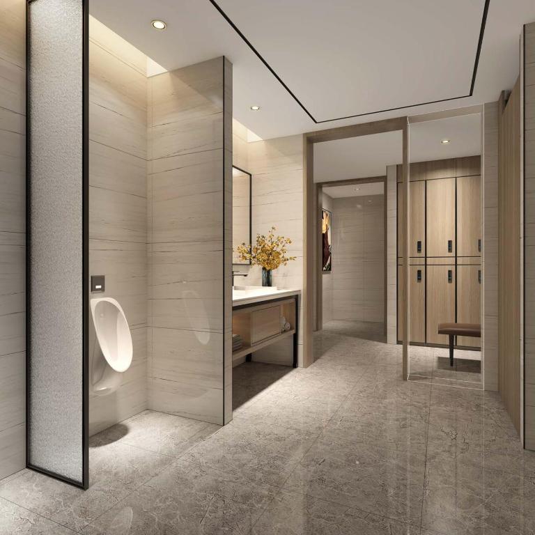 a bathroom with a toilet and a sink and a mirror at Argyle Grand Hotel Nairobi Airport in Nairobi