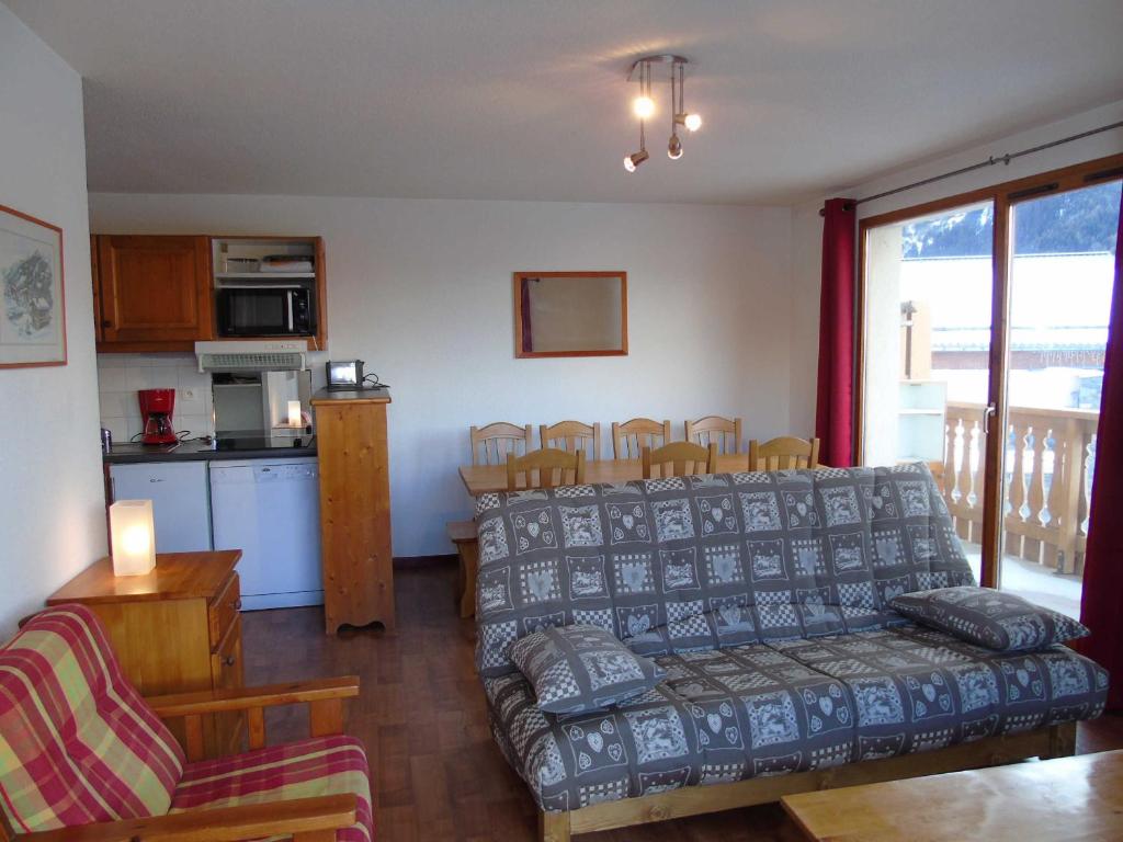 a living room with a couch and a table at Appartement Valfréjus, 4 pièces, 8 personnes - FR-1-561-45 in Valfréjus