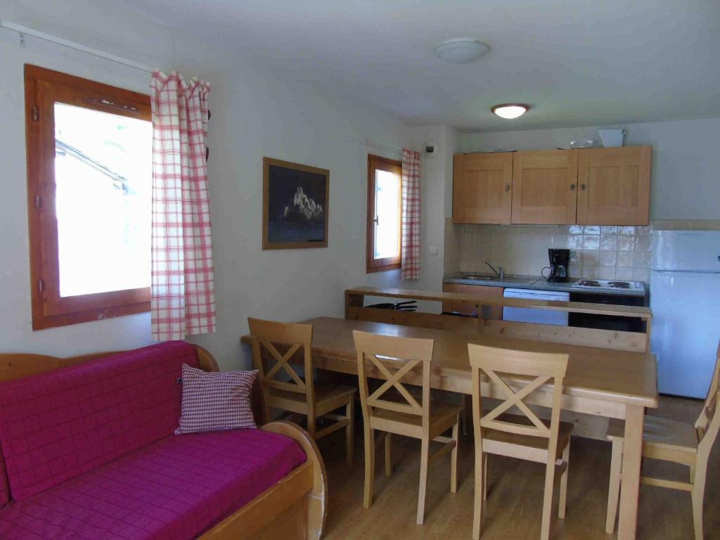 a living room with a couch and a table and a kitchen at Appartement Valfréjus, 3 pièces, 8 personnes - FR-1-561-59 in Valfréjus