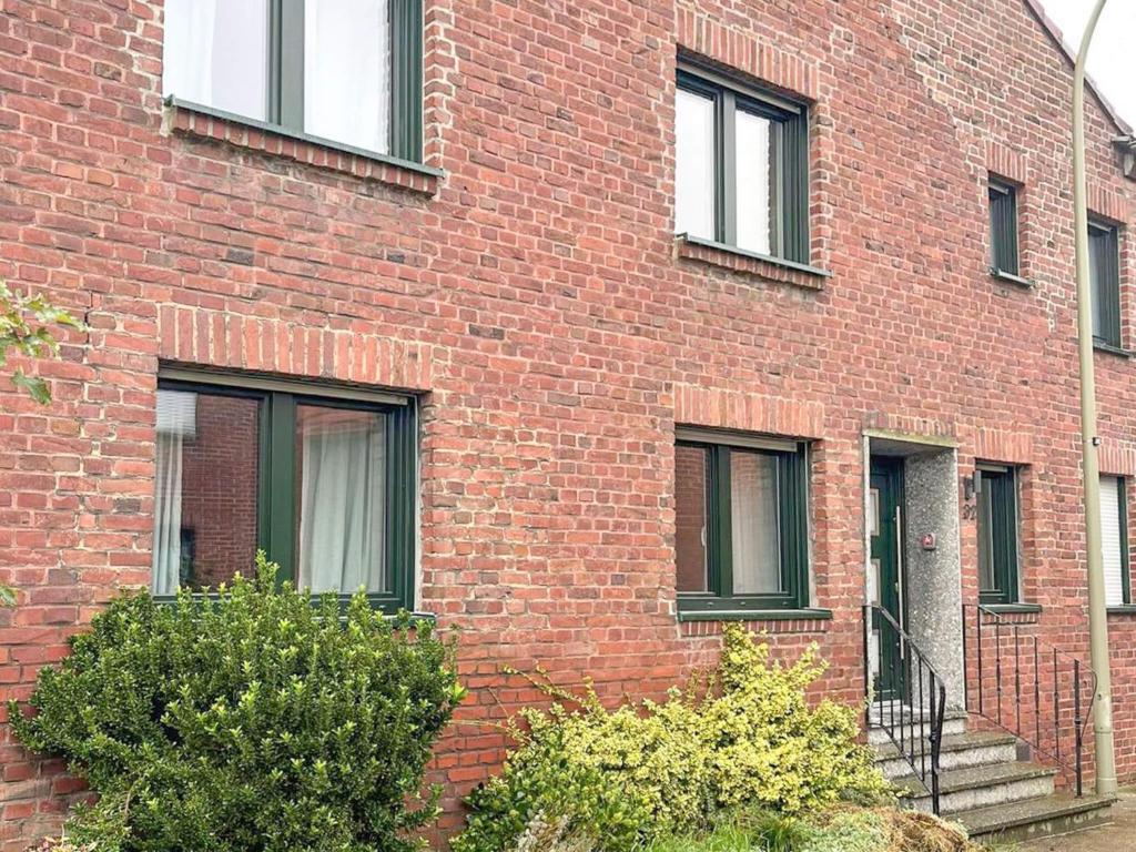 a red brick building with stairs on the side of it at T&K Apartments - Wegberg - 3-6 Zimmer Apartments in Wegberg