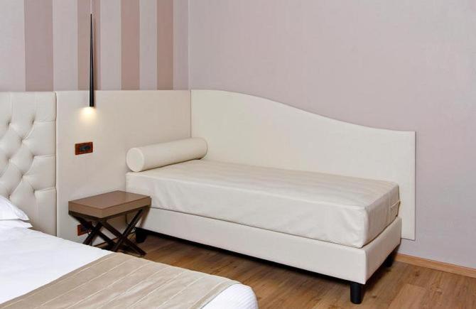 Postel nebo postele na pokoji v ubytování Hotel Arcangelo