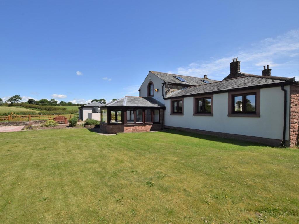 a house with a large lawn in front of it at 3 bed property in Wigton 83471 in Aikton