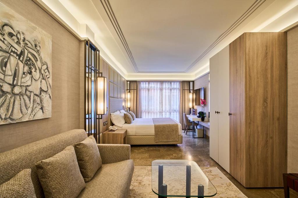 a hotel room with a bed and a couch at VP Madroño in Madrid
