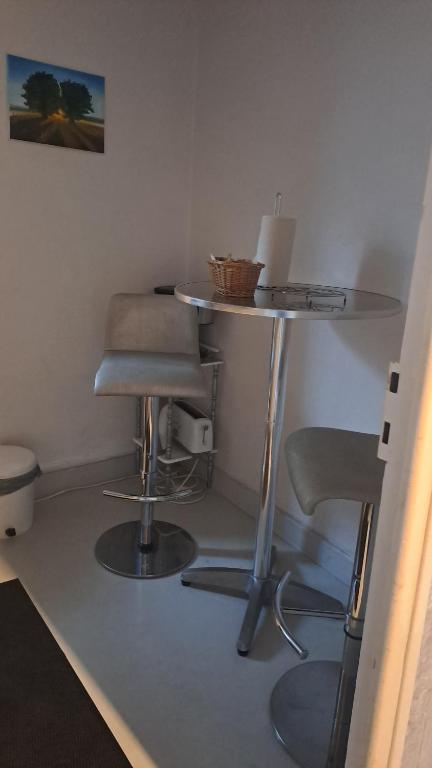 a table and two stools in a room at Studio in Aurillac