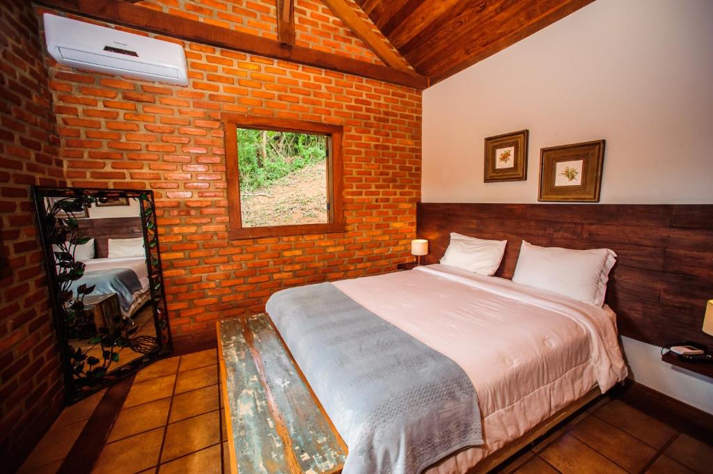Cama ou camas em um quarto em Serra do Ibitipoca Hotel de Lazer