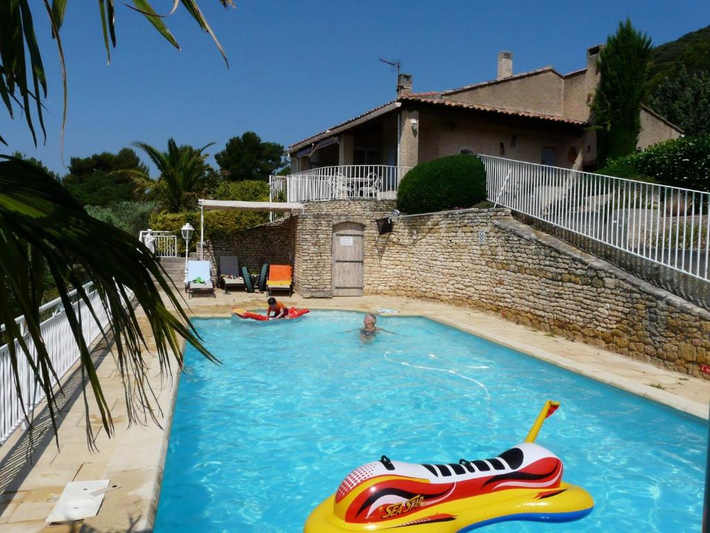 a large swimming pool with a inflatable boat in it at vacation home with private swimming-pool and a nice view on the luberon mountain, located in merindol, 8 persons in Mérindol