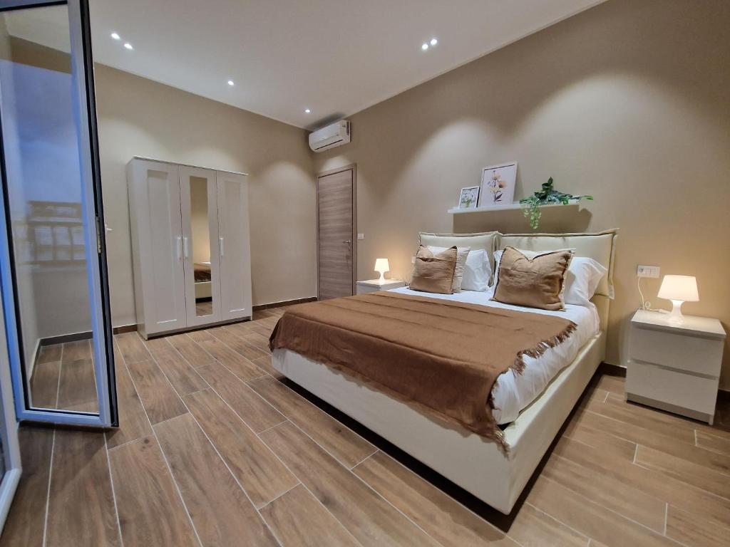 um quarto com uma cama grande e um espelho em Piccole Donne em Nápoles