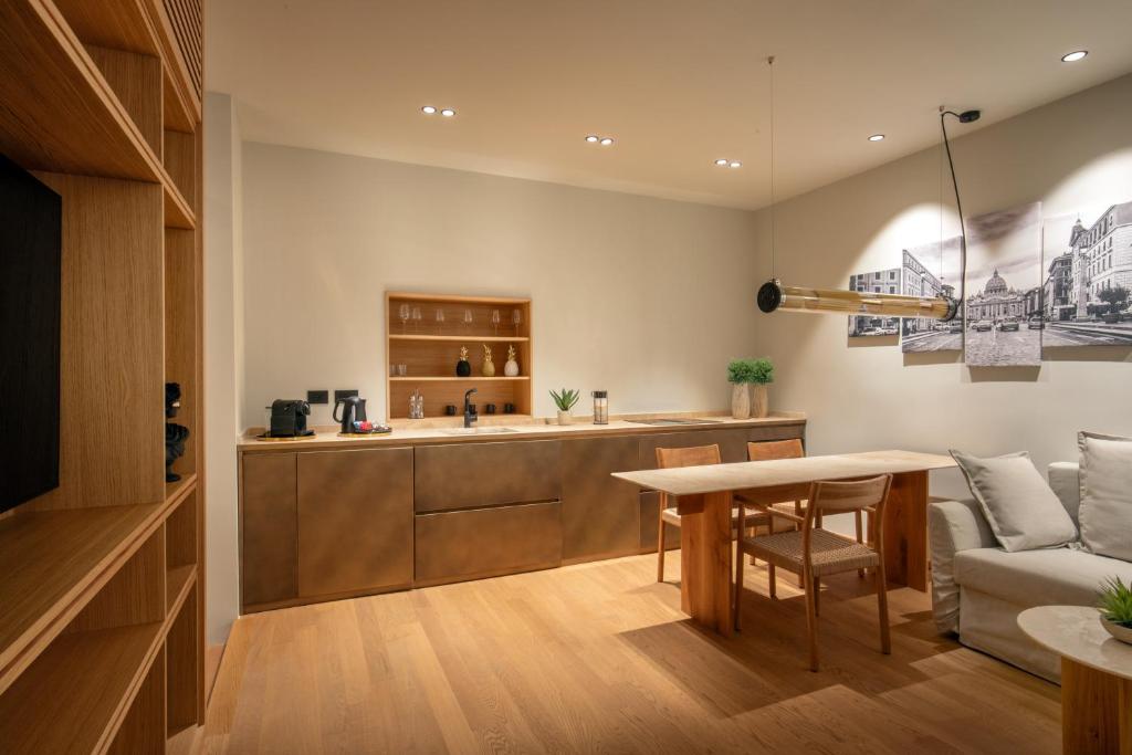 a kitchen and living room with a table and a couch at Ripetta Luxury Apartments in Rome