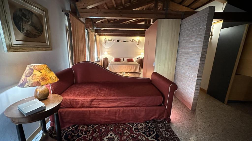 a living room with a couch and a bedroom at San Simeon Apartments in Venice