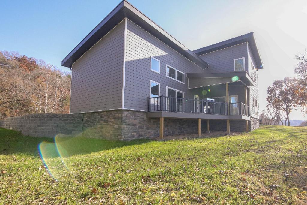 a house on a hill with a large yard at Bright Cotter Vacation Rental with White River Views in Cotter