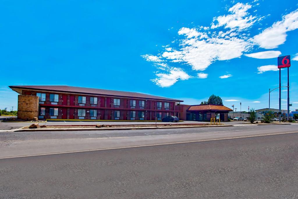 a red building on the side of a road at Motel 6 Willcox, AZ in Willcox