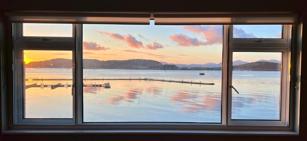 a window with a view of a body of water at Island View in Oban