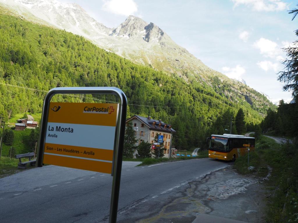 a sign on the side of a road with a mountain at Aiguille de La Tza in Arolla