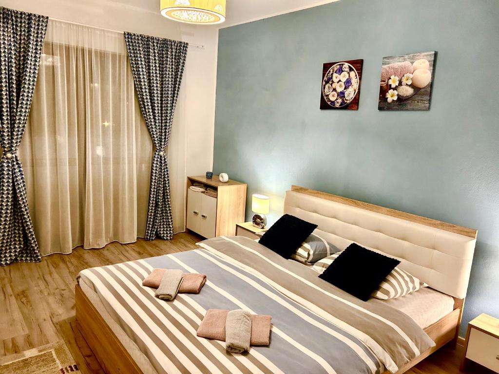 a bedroom with a large bed with two pillows at STEFI ' s Apartament in Sibiu
