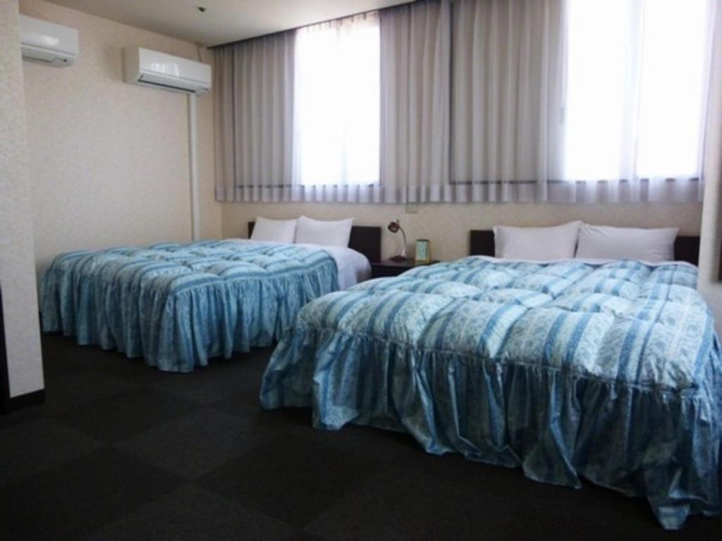 a hotel room with two beds with blue sheets at Hotel Wakow - Vacation STAY 22138v in Yonago