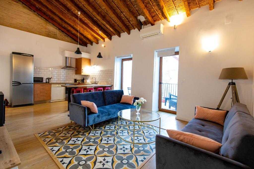 a living room with two couches and a table at Casa Olivera in Denia