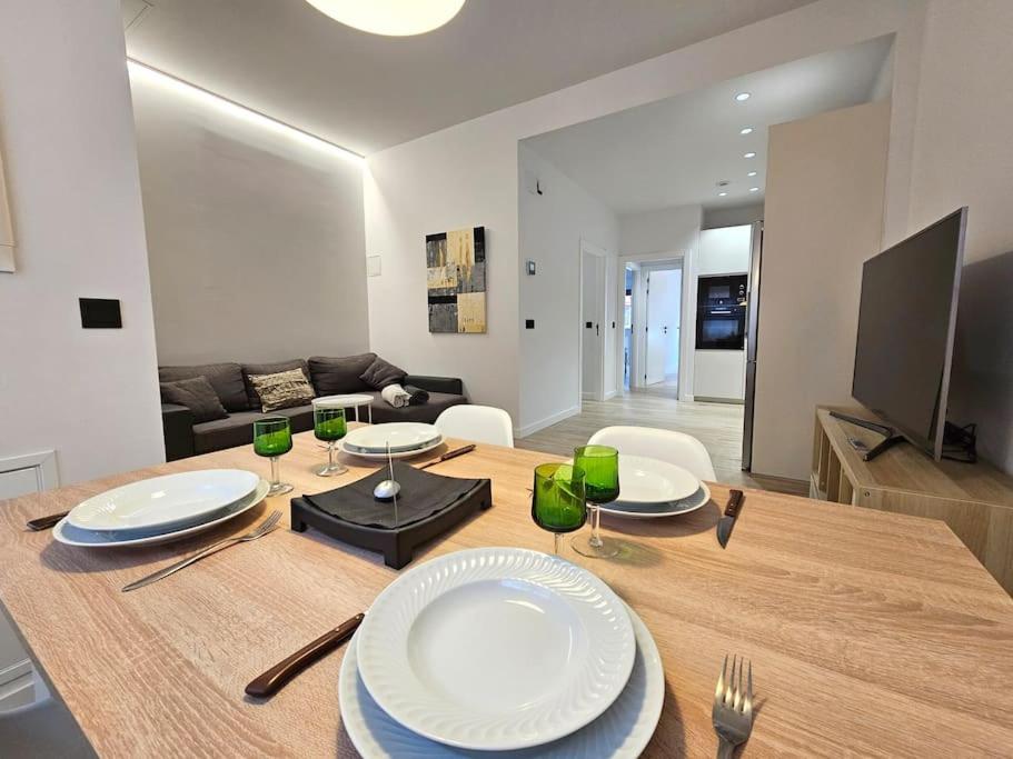 a living room with a wooden table with plates on it at Loft céntrico y acogedor UAT01526 in Pamplona